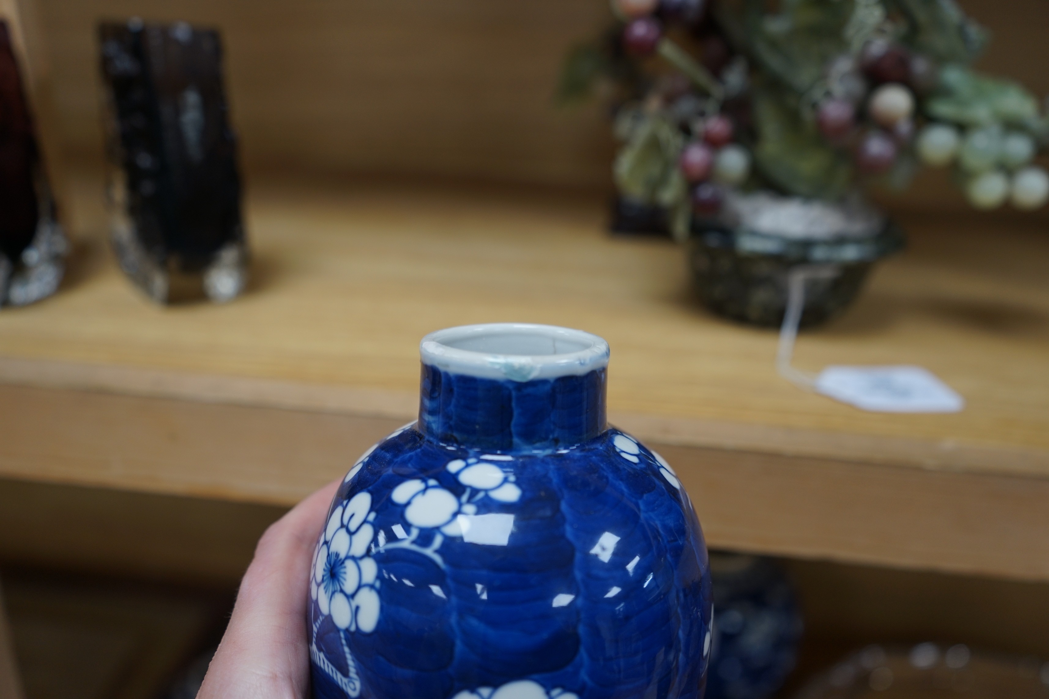 A group of Chinese blue and white prunus vases and jars and covers and jars, pair of vases 23 cms high